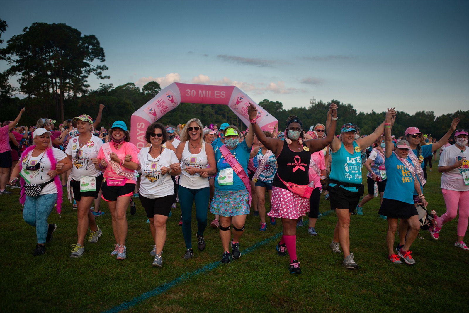 Registrants holding hands at the start line