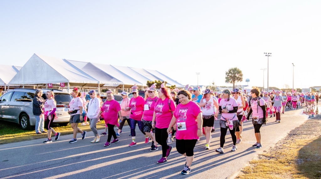 Hundreds of registrants in pink leaving the start tents
