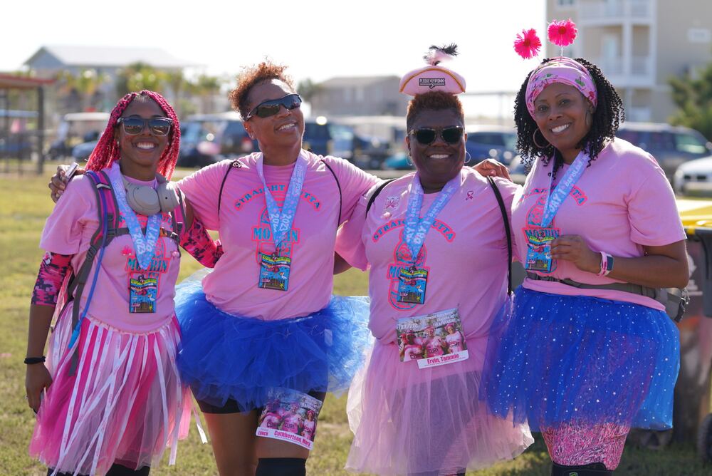 Four women in tutus and medals posing together