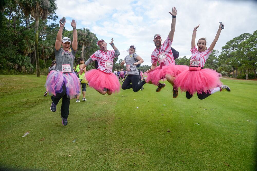 FlockStars in pink tutus jumping for joy on a golf course