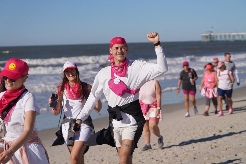 FlockStars in pink bandanas walking along the beach