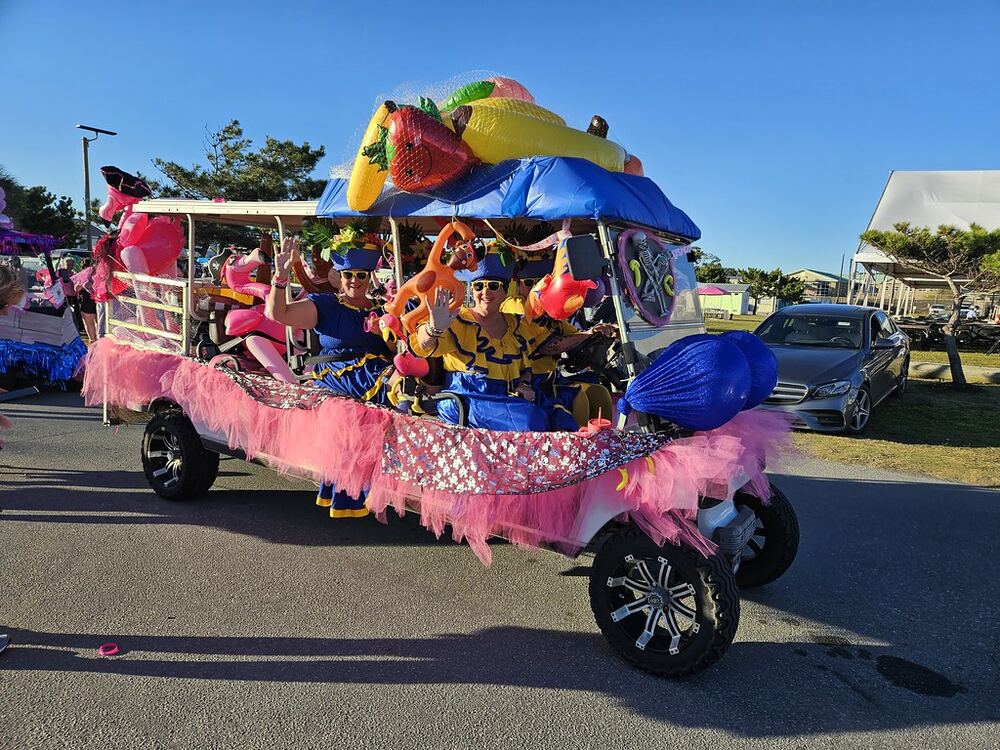 Golf cart decorated with fruit floats and pink tulle for the parade
