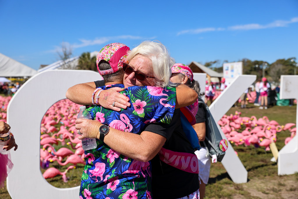 Three costumed FlockStars standing in the Flocks of Love flamingo field