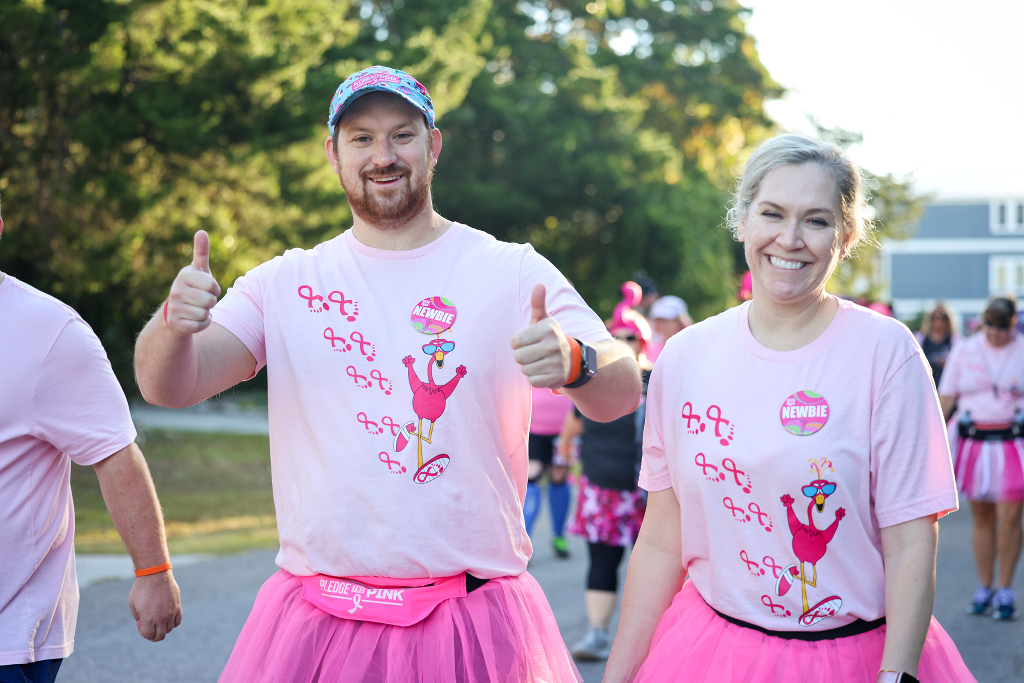 Two first-year FlockStars in pink tutus giving thumbs up