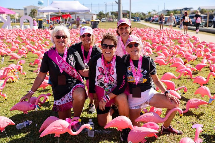 Five Pledge the Pink FlockStars posing among the flamingo flock