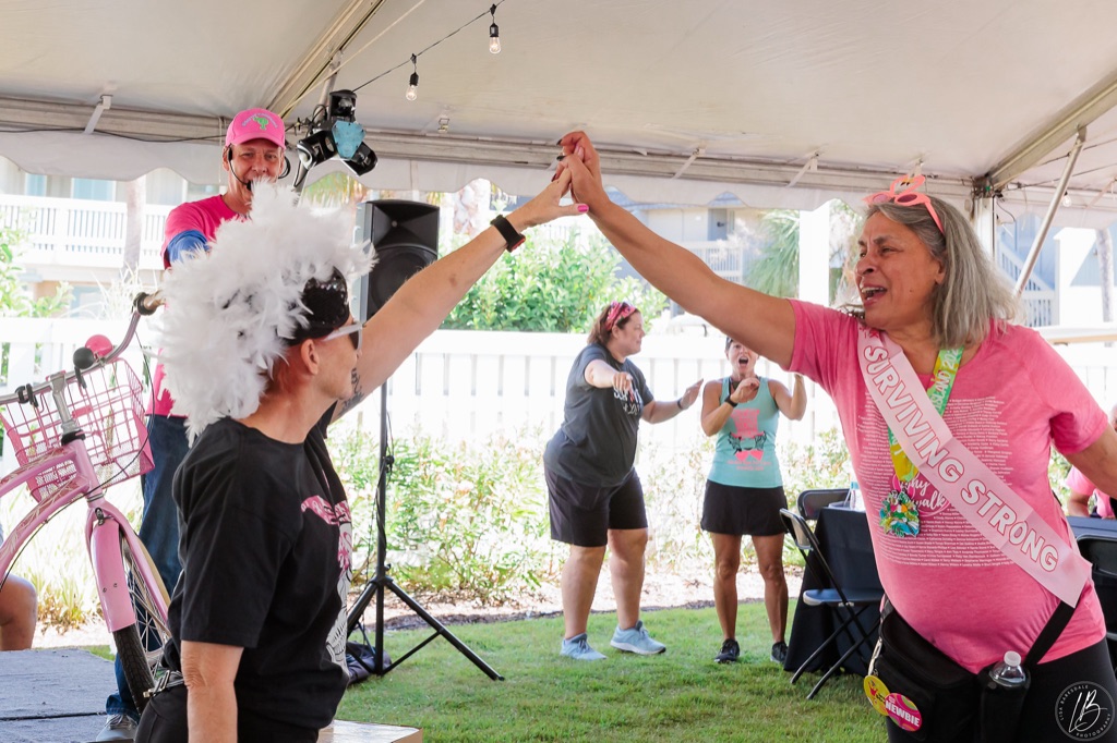 Winning bidder celebrating a pink bicycle