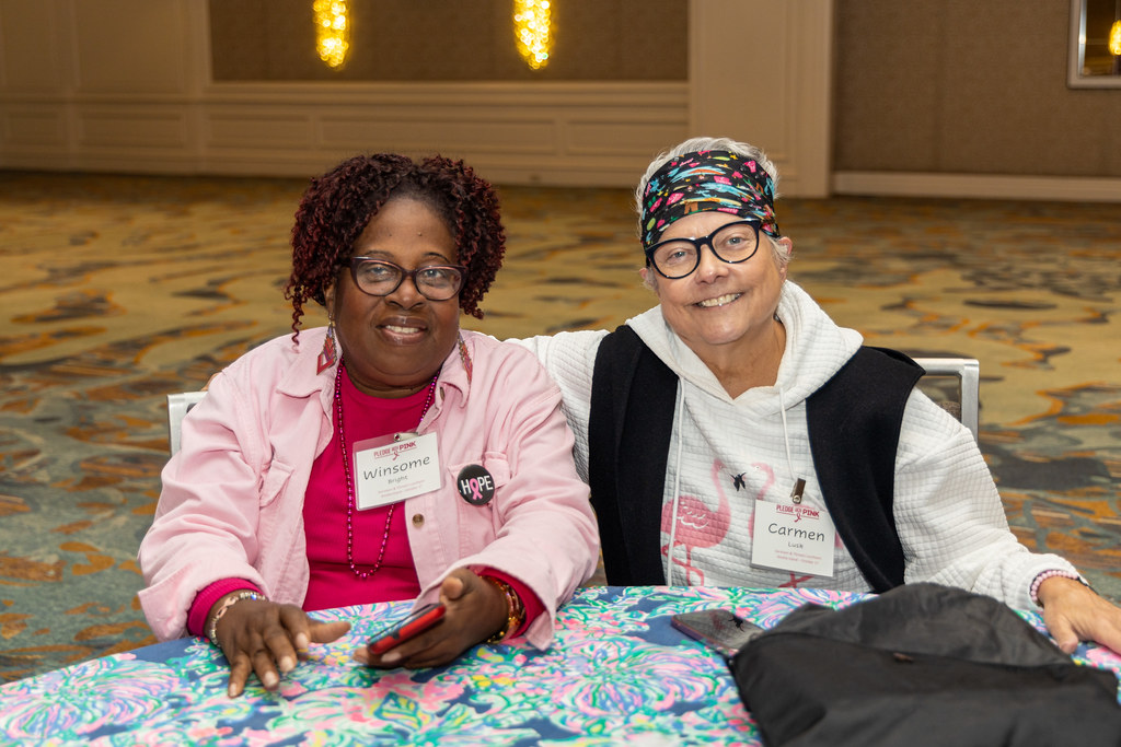 Two survivors seated side by side at the luncheon
